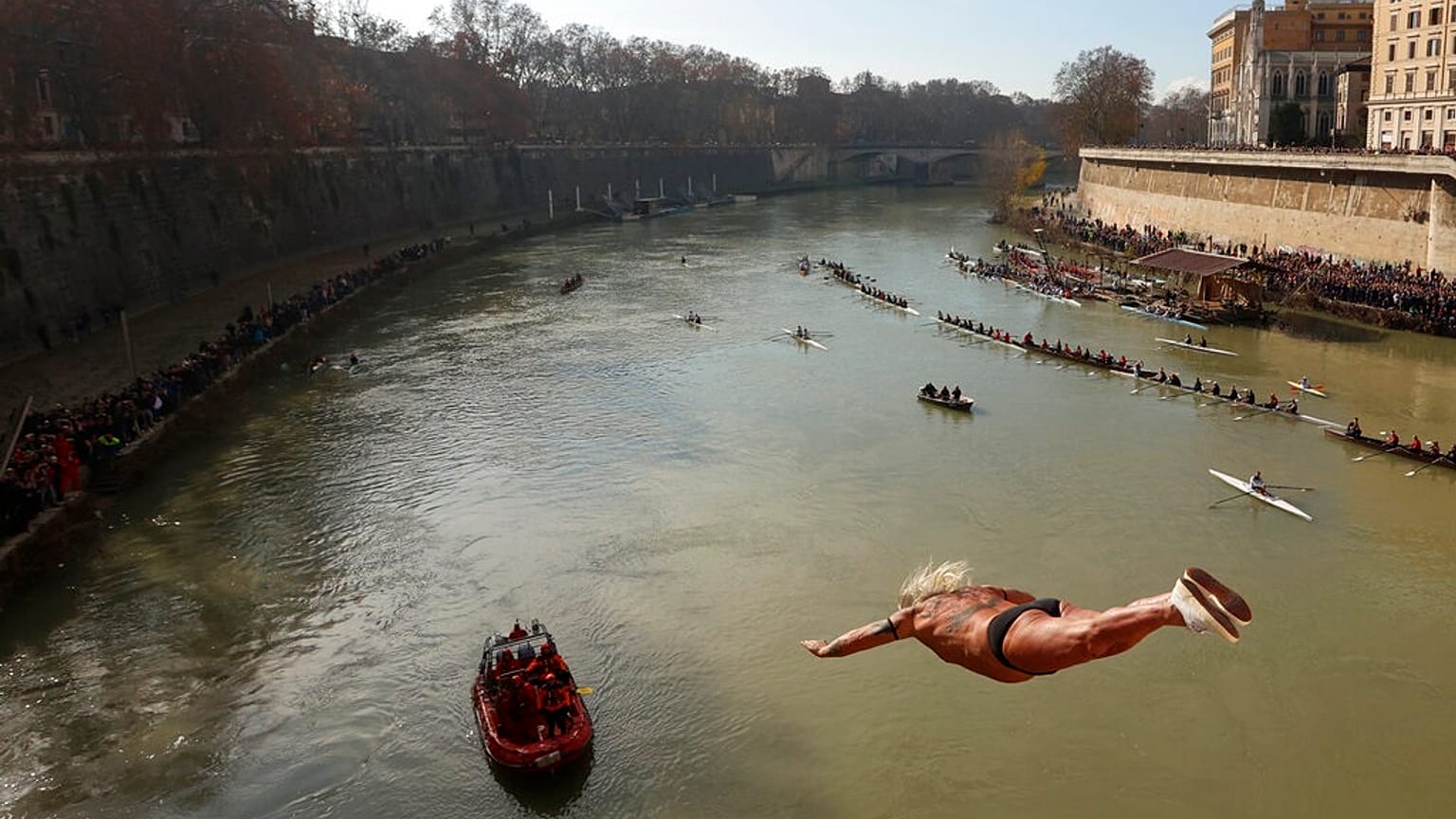 An italian man dives into the Tiber river from the 18 meter (59 feet) high Cavour Bridge.