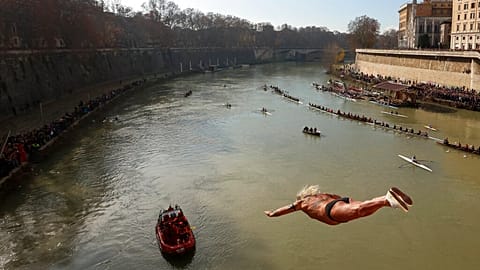 An italian man dives into the Tiber river from the 18 meter (59 feet) high Cavour Bridge.