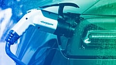 An electric car is charged at a charging station in a parking lot, May 2023