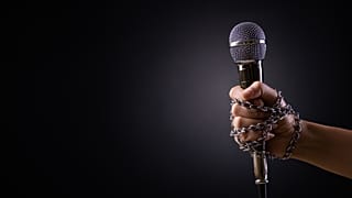 A microphone in chains.