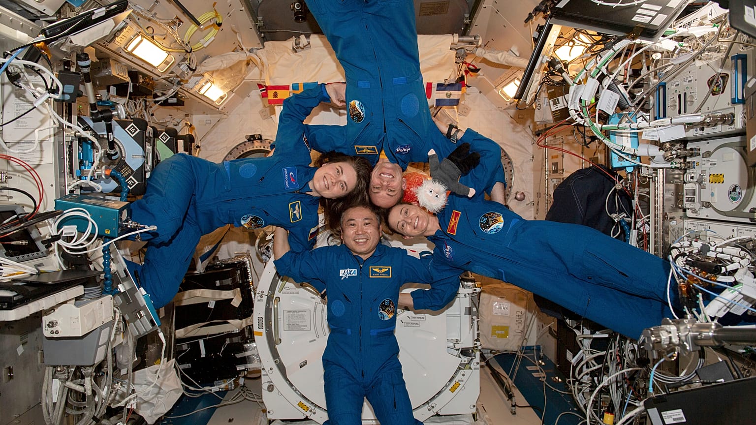 Clockwise from left, Expedition 68 Flight Engineers Anna Kikina of Roscosmos, Josh Cassada and Nicole Mann from NASA, and Koichi Wakata of JAZA gather inside the ISS.