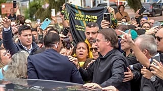Brazil's former President Jair Bolsonaro is greeted by supporters after landing at the airport in Porto Alegre, Brazil, Thursday, June 22, 2023