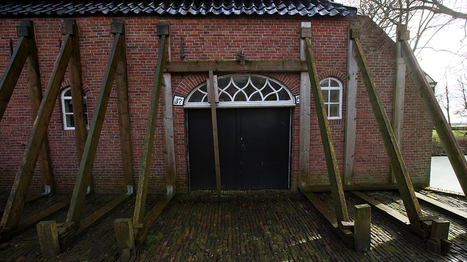 FILE - Support beams stabilize an historic farm in Hunzinge, northern Netherlands, on Jan. 19, 2018. 