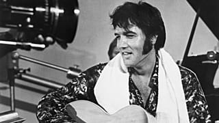 Elvis in happier times - seen here playing guitar in a scene from the documentary film Elvis: That's the Way It Is