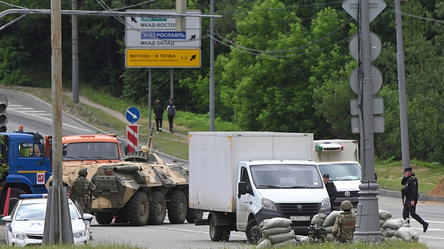 Russian army servicemen, and police officers guard the highway at the entrance to Moscow, Russia, Saturday, June 24, 2023.
