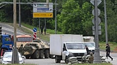 Russian army servicemen, and police officers guard the highway at the entrance to Moscow, Russia, Saturday, June 24, 2023.