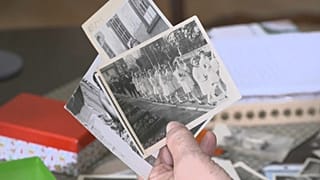 Una víctima de los desplazamientos forzosos de la RDA muestra fotos de su infancia