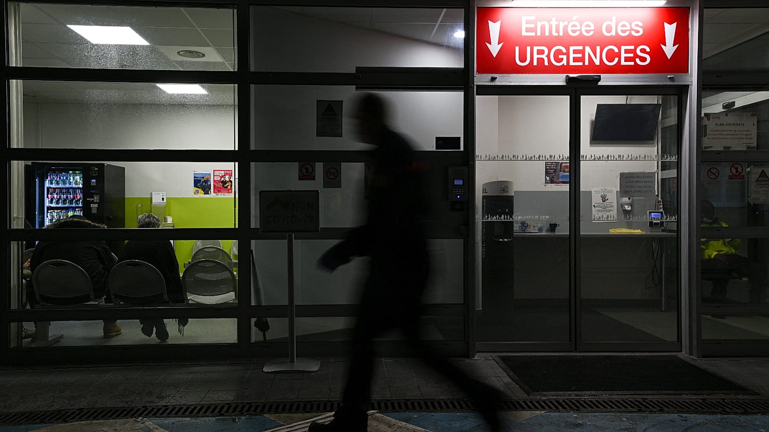 A man passes by an entrance of the emergency department of Emile Muller Hospital in Mulhouse on 16 January 2023.