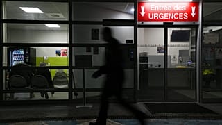 A man passes by an entrance of the emergency department of Emile Muller Hospital in Mulhouse on 16 January 2023.