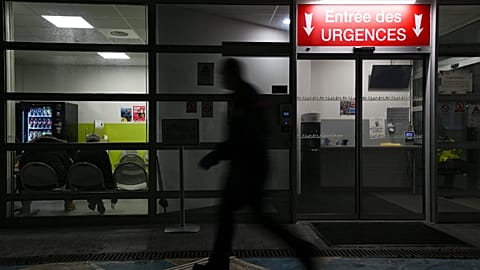A man passes by an entrance of the emergency department of Emile Muller Hospital in Mulhouse on 16 January 2023.