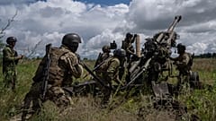 Ukrainian servicemen prepare to fire at Russian positions from a US-supplied M777 howitzer in Kharkiv region, Ukraine. More US funding for Ukraine was due to be announced. 