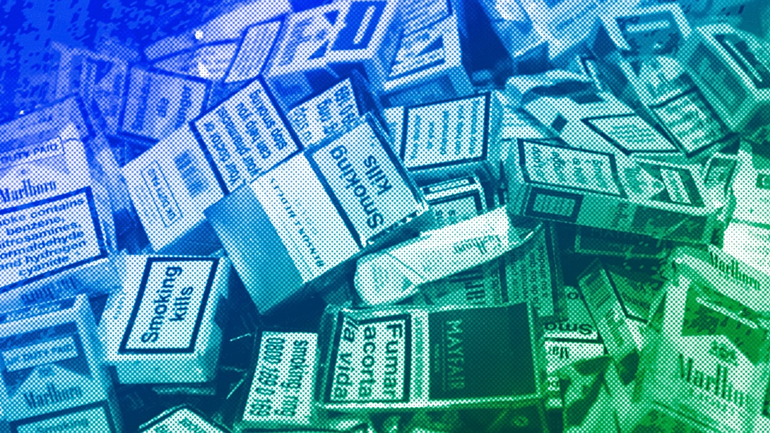 Discarded cigarette cartons lie on the floor in a bar in central London, January 2007