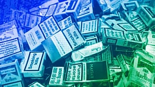 Discarded cigarette cartons lie on the floor in a bar in central London, January 2007