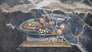 Archaeologists carefully excavate the wall where the ‘pizza’ fresco was found on the northeastern end of the archaeological park