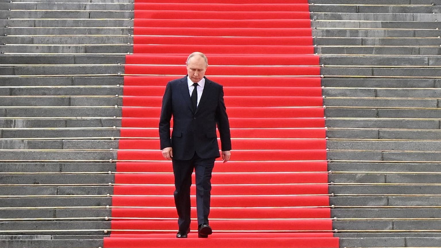 Russian President Vladimir Putin walks down the steps to address troops from the defence ministry on the grounds of the Kremlin in central Moscow on June 27, 2023.