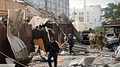 In this photo provided by the National Police of Ukraine, a police officer and a rescue worker walk through Kramatorsk after a Russian attack on 27 June, 2023