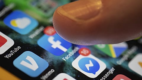 An iPhone displays the apps for social media platforms. 