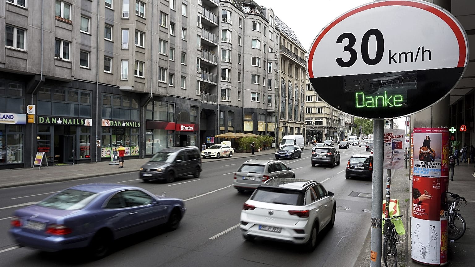 Cars pas by a speed limit traffic sign at the 'Leipziger Strasse' in Berlin, Germany.