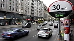 Cars pas by a speed limit traffic sign at the 'Leipziger Strasse' in Berlin, Germany.