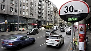 Cars pas by a speed limit traffic sign at the 'Leipziger Strasse' in Berlin, Germany.