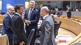 France's President Emmanuel Macron, second left, speaks with Germany's Chancellor Olaf Scholz, right, during a round table meeting at an EU summit in Brussels, June 29, 2023. 