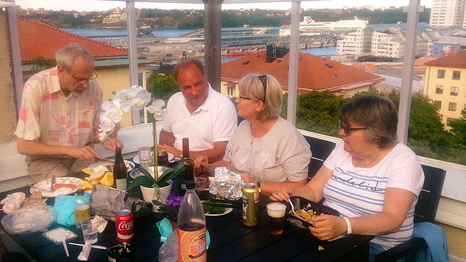 Residents have dinner on the terrace of the Regnbågen retirement community rooftop, in Stockholm.