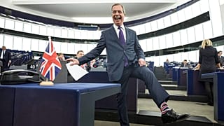 Former UK Independence Party (UKIP) leader and member of the European Parliament Nigel Farage shows his socks at the European Parliament in Strasbourg, France, 2019.