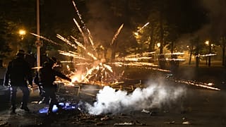 Police clear a street on the third night of protests sparked by the fatal police shooting of a 17-year-old driver in the Paris suburb of Nanterre, France.