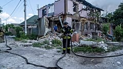 Ukrainian State Emergency Service firefighters put out a fire at a house destroyed in a Russian shelling, in a residential neighbourhood, in Kherson, Ukraine, Saturday, July 1