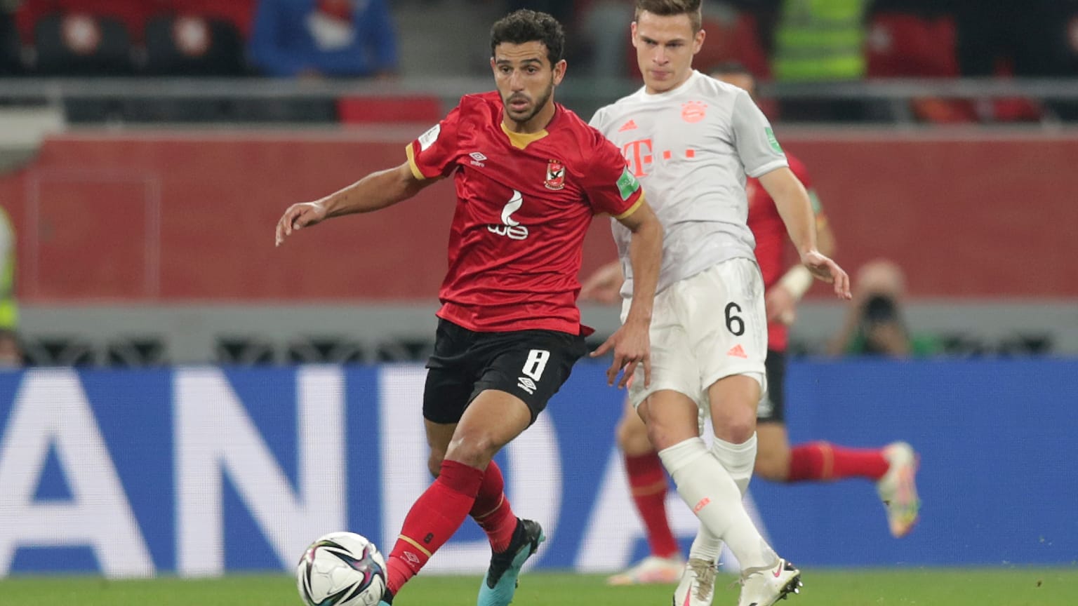 لاعب وسط النادي الأهلي المصري حمدي فتحي أمام جوشوا كيميش لاعب بايرن ميونيخ