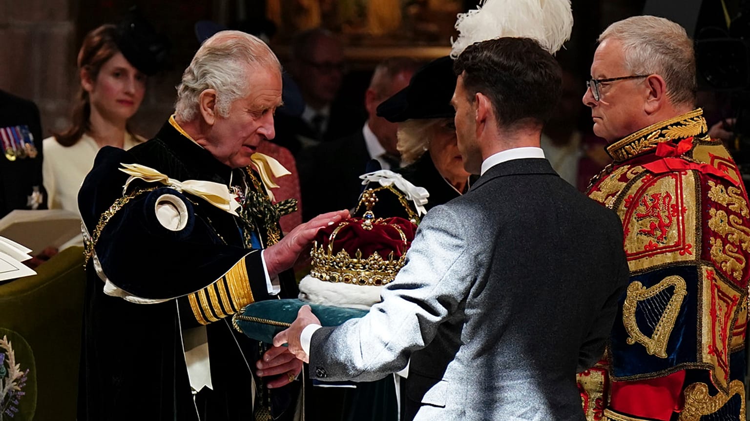 Britain's King Charles III is presented with the Crown of Scotland during the National Service of Thanksgiving and Dedication for King Charles III and Queen Camilla