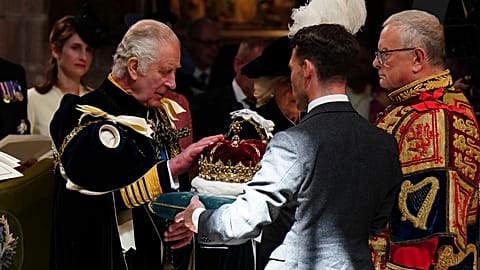 Britain's King Charles III is presented with the Crown of Scotland during the National Service of Thanksgiving and Dedication for King Charles III and Queen Camilla
