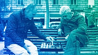 People play chess in a park outside the national theatre in Sofia, April 2023