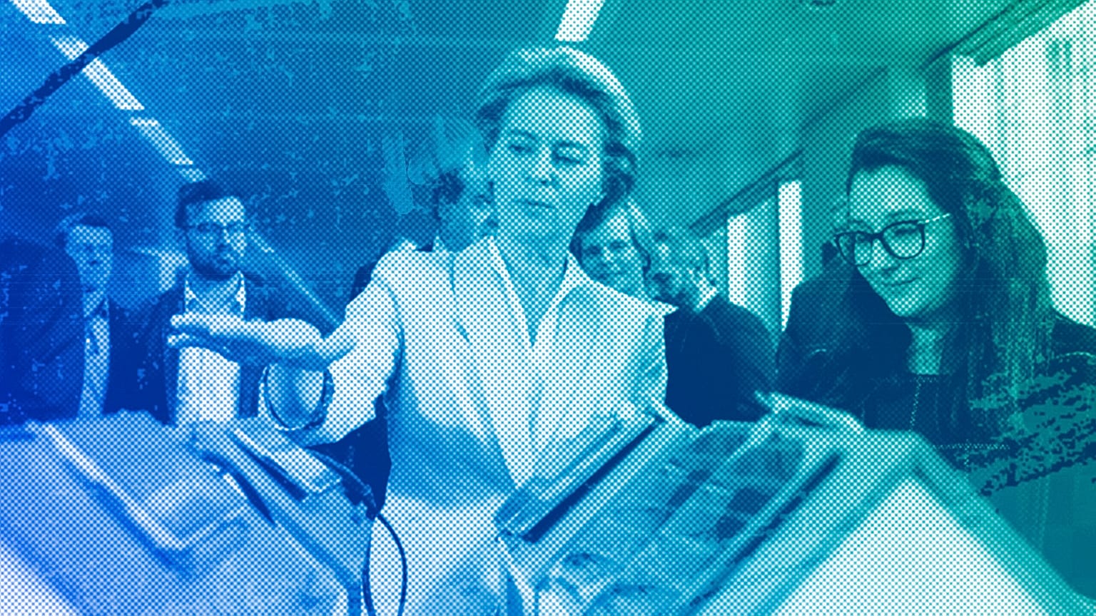 European Commission President Ursula von der Leyen looks at an invention at the AI Xperience Center at the Vrije Universiteit Brussel) in Brussels, February 2020