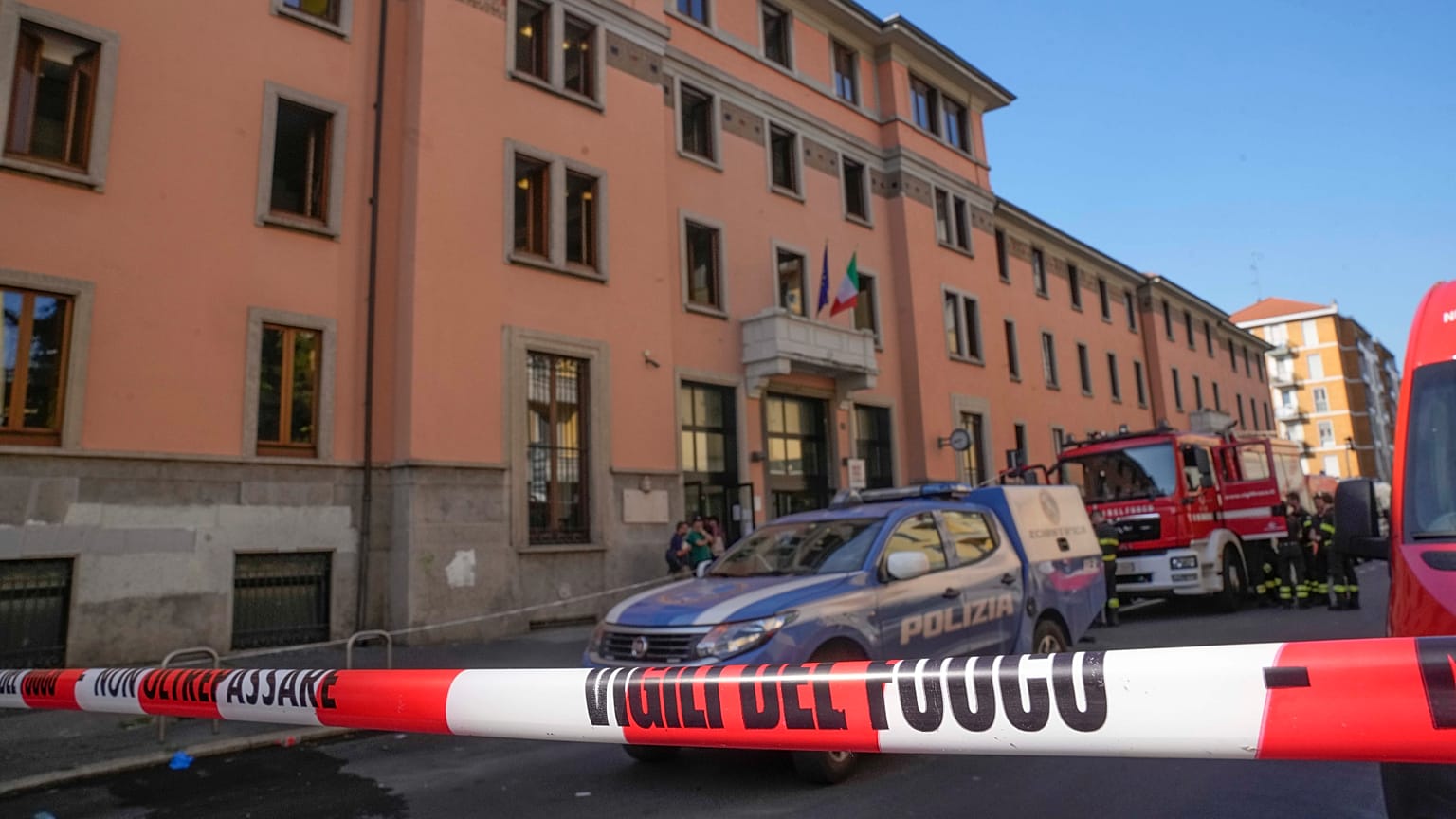 A firefighter truck and a police car are parked outside the "Casa per Coniugi" nursing home