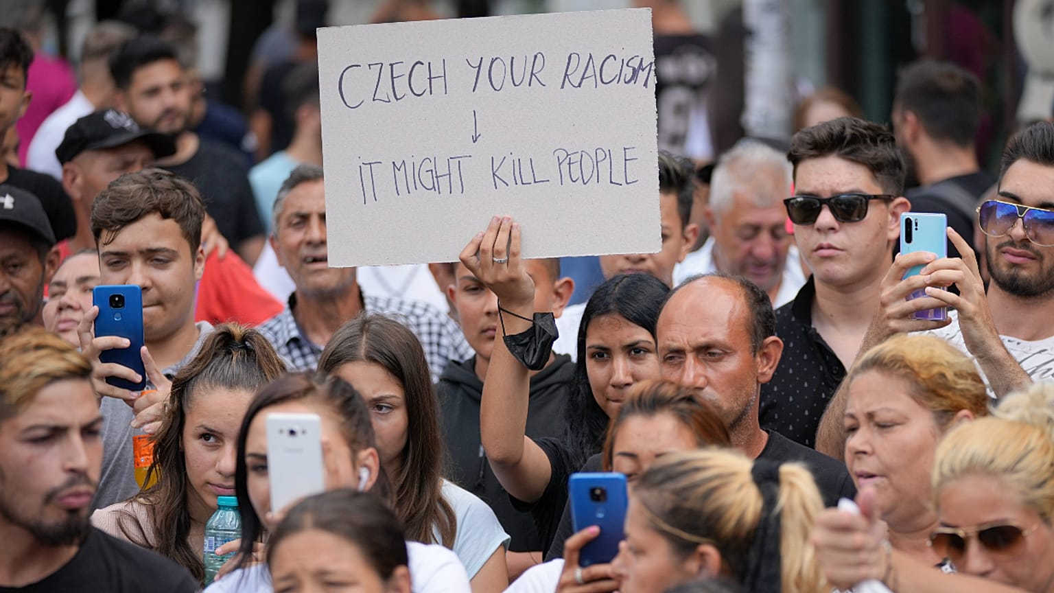 People hold banners during a rally in Romania by Roma organizations to honor a Stanislav Tomas, who was killed by police officers in the Czech Republic. 29 June 2021