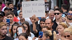 People hold banners during a rally in Romania by Roma organizations to honor a Stanislav Tomas, who was killed by police officers in the Czech Republic. 29 June 2021