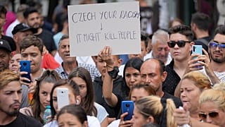 People hold banners during a rally in Romania by Roma organizations to honor a Stanislav Tomas, who was killed by police officers in the Czech Republic. 29 June 2021
