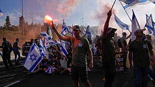 Demonstrators block a highway leading to Jerusalem, during a protest against plans by Prime Minister Benjamin Netanyahu's new government to overhaul the judicial system.