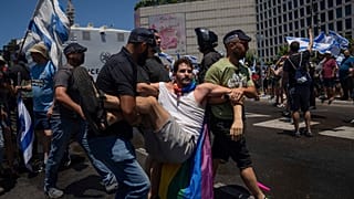 Israeli police detain a demonstrator during a protest against plans by Prime Minister Benjamin Netanyahu's new government to overhaul the judicial system, in Tel Aviv.