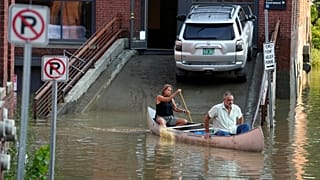 Residents in Montpelier, Vt use a canoe to remove surgical supplies from the flood-damaged centre, Tuesday, July 11, 2023