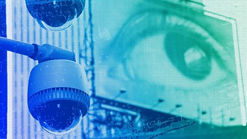 Security cameras mounted on the side of a building overlooking an intersection