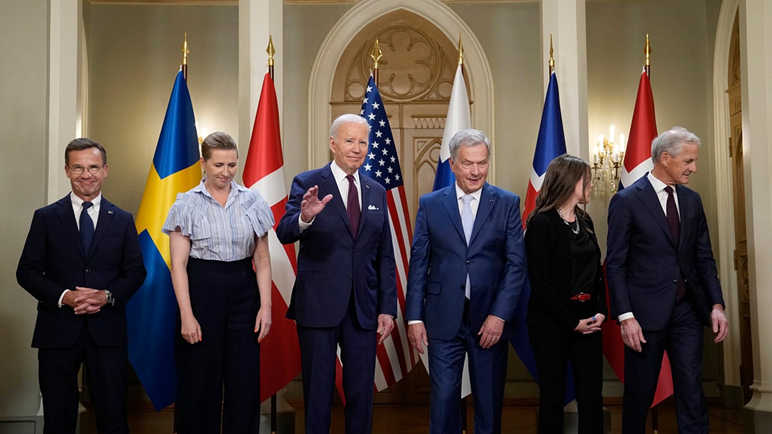 President Joe Biden waves following a family photo with Nordic leaders  at the Presidential Palace in Helsinki, Finland, Thursday, July 13, 2023.
