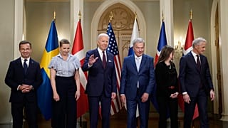 President Joe Biden waves following a family photo with Nordic leaders  at the Presidential Palace in Helsinki, Finland, Thursday, July 13, 2023.