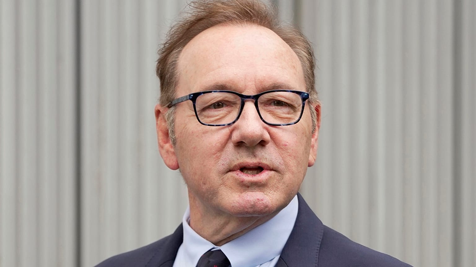 Actor Kevin Spacey looks on as he arrives at Southwark Crown Court, London