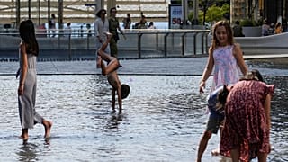 Kinder kühlen sich in Mailand am 15. Juli 2023