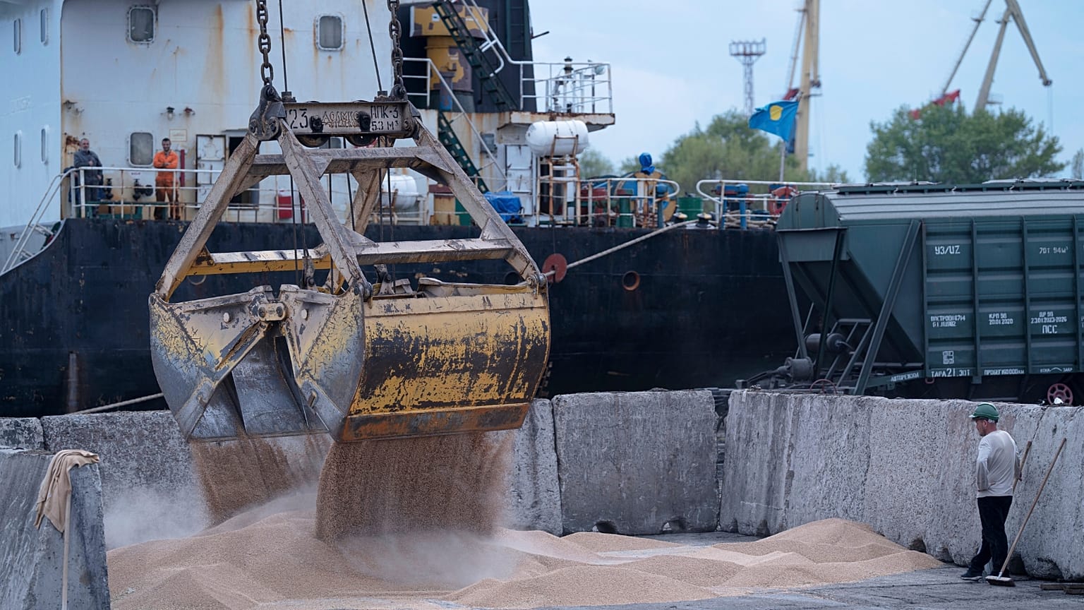 FILE - Workers load grain at a grain port in Izmail, Ukraine, on April 26, 2023.