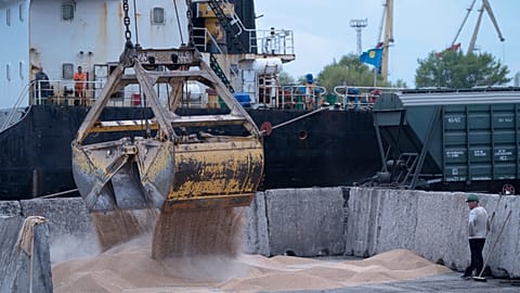 FILE - Workers load grain at a grain port in Izmail, Ukraine, on April 26, 2023.