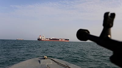FILE - A July 21, 2019 photo of a speedboat of Iran's Revolutionary Guard training a weapon toward the British-flagged oil tanker Stena Impero, seized in the Strait of Hormuz.