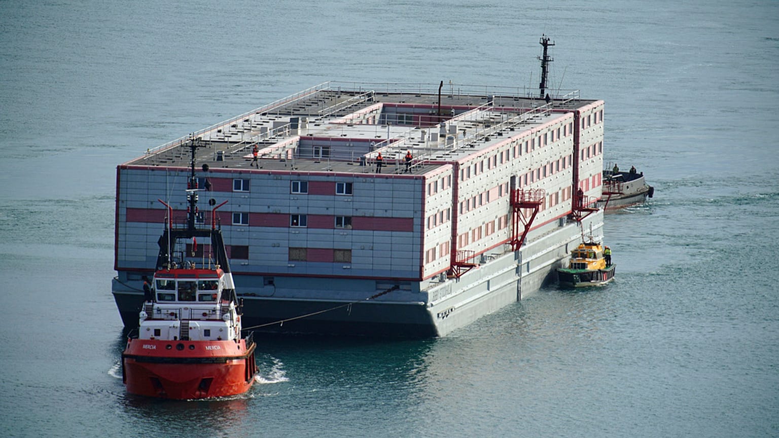 Tug boat Mercia pulls the Bibby Stockholm accommodation barge into Portland in Dorset where it is due to house migrants.